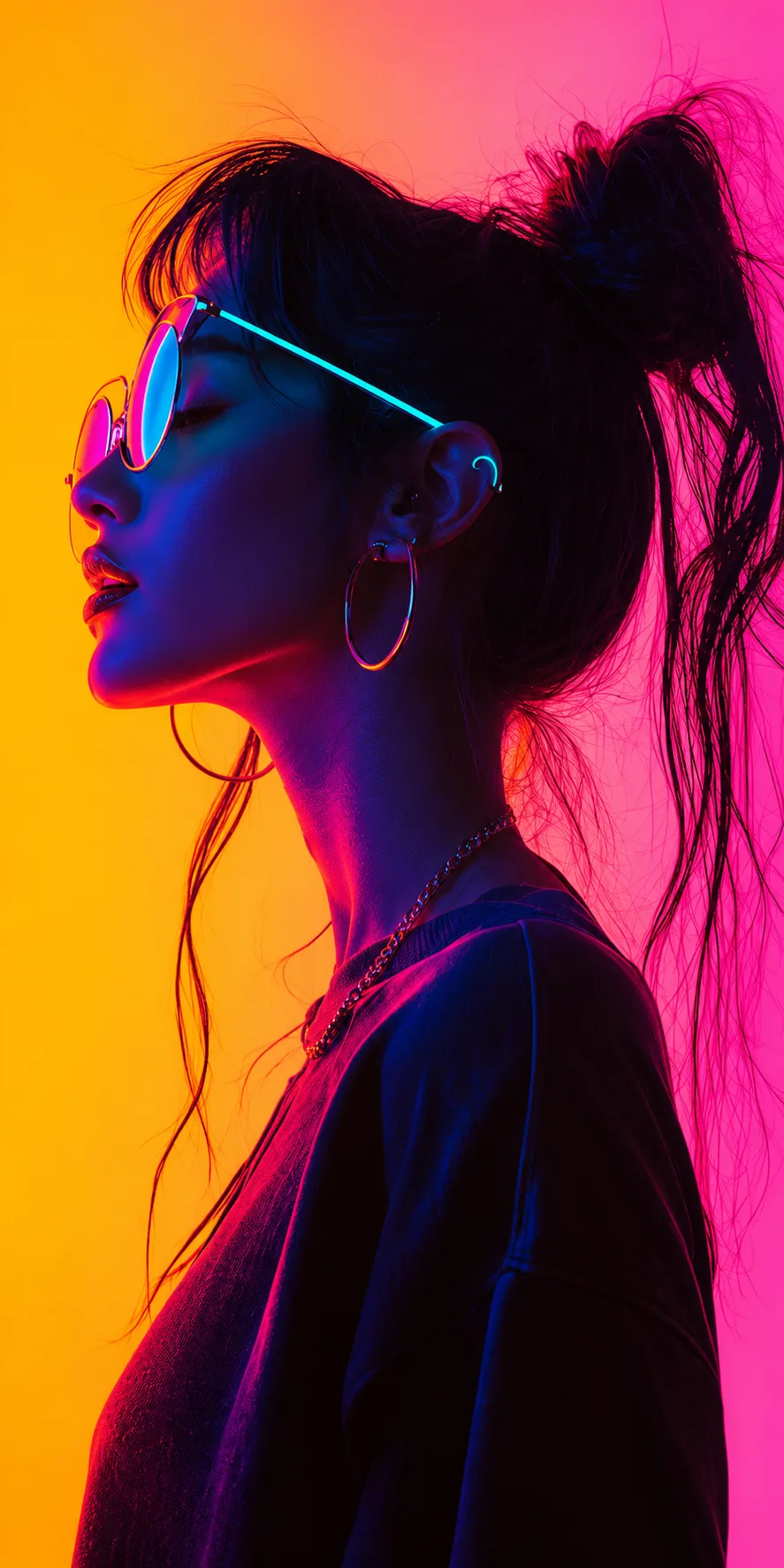 Portrait of a woman in profile wearing tinted glasses against an orange and pink background